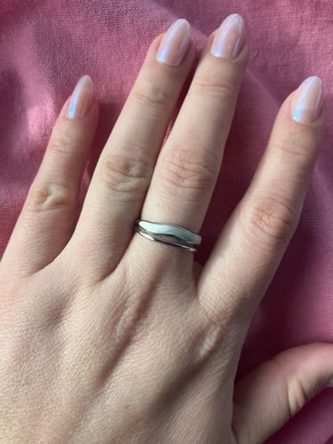 Reviewer wearing the Layered Sahara Silver Ring, showing its simple, wavy design on their finger.