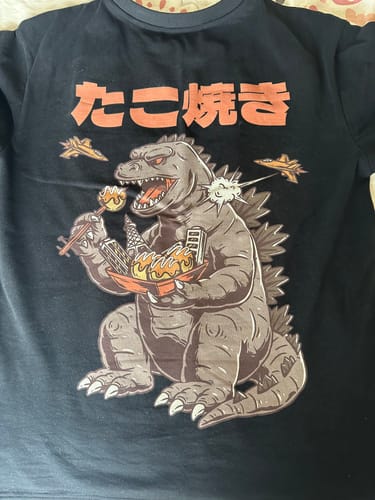 Customer's black Snackzilla T-Shirt with a detailed graphic of a monster eating takoyaki.