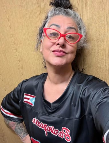 Customer wearing the black Puerto Rico Heritage custom football jersey with the flag patch visible on the sleeve.