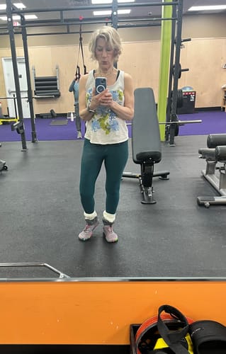 Reviewer wearing purple Smart II - Barefoot Shoes with white cuffs while standing in a gym.
