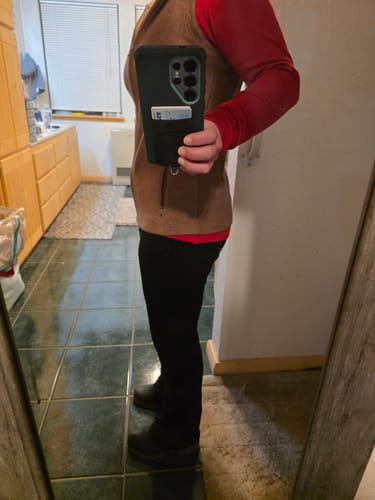 Reviewer showing the side profile fit of the black Emerson Straight Leg Pants indoors.