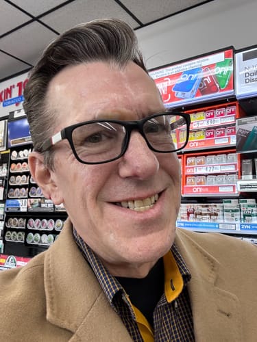 Reviewer with clear skin smiling in a store, showing results from the Clear Skin Formula Acne Nutraceutical.