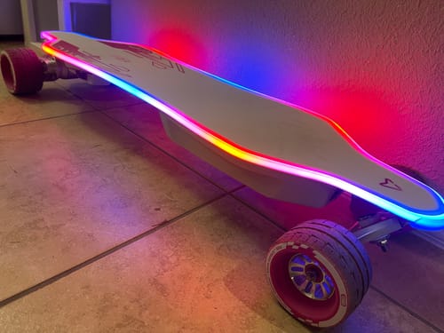 Customer's Meepo Voyager X electric skateboard indoors, showing its colorful RGB lights glowing along the deck.