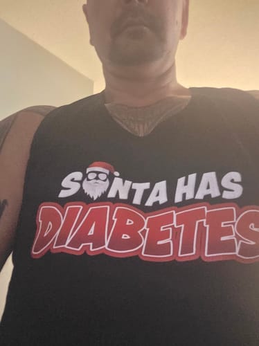 Reviewer's close-up wearing the black Santa Has Diabetes Premium Tank Top.