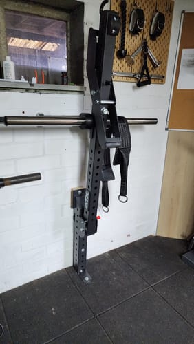 Customer's Riot MRR 75 Low Profile Foot bolted to the floor, used to create a custom wall-mounted belt squat station.