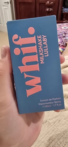 Customer's hand holding the blue box for the Milkshake Lullaby fragrance.