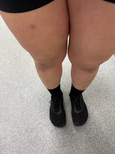 A top-down view of a reviewer wearing the black Smart Ⅰ - Barefoot Shoes with black socks on a grey floor.