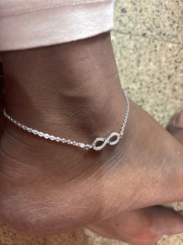 Customer wearing the Silver Infinity Zircon Anklet, showing the detailed zircon-studded infinity symbol on their ankle.