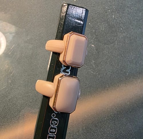 Reviewer's new and old Emerald Collection silicone rings displayed on a pencil for comparison.