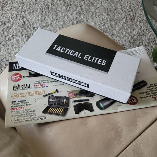 Packaging for the customer's Site Right™ 2.0 - Boresighter shown resting on a catalog.