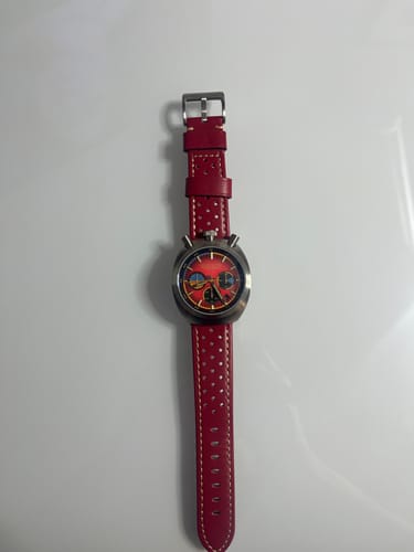 Customer's watch showing the red perforated Leather Sport Grip strap with light tan stitching.