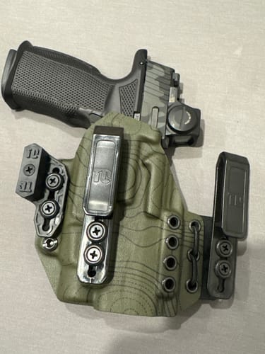 Customer's green topographic XIPHOS ELITE holster holding a handgun with an optic.