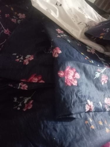 Close-up of the customer's dark SOHAUS Comforter Set with a pink floral pattern, partially removed from packaging.