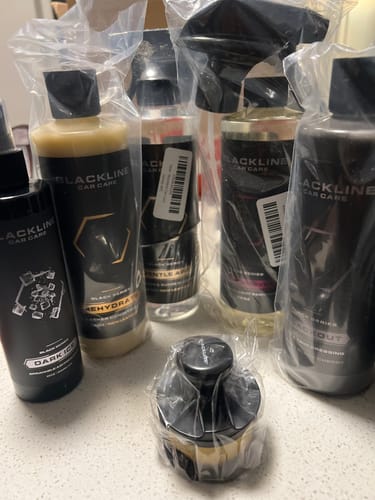 Customer's collection of new Blackline car care products still in their plastic wrapping.