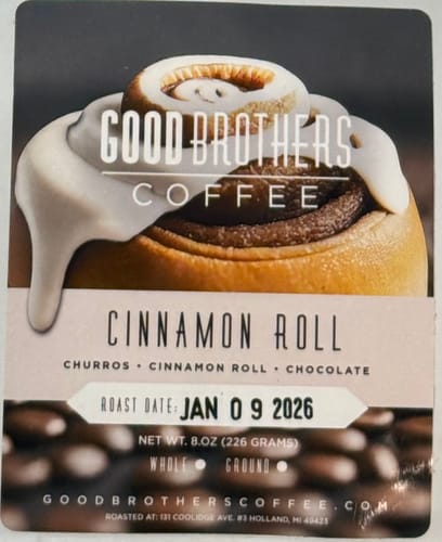 Customer's close-up of the Cinnamon Roll coffee packaging, showing the label with a large frosted cinnamon roll.