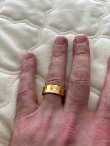 Customer wearing the wide, gold 1 oz American Gold Eagle Coin Ring on their finger.