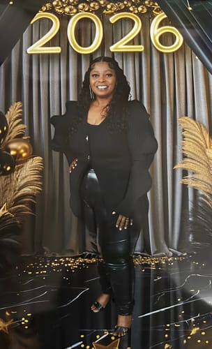 Reviewer posing in a stylish black Wave Sleeve V-Neck Knitted Cardigan at an event.