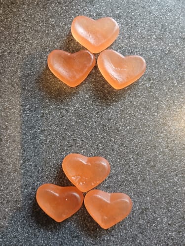 Customer's six heart-shaped Peach Hormone Gummies arranged on a countertop.