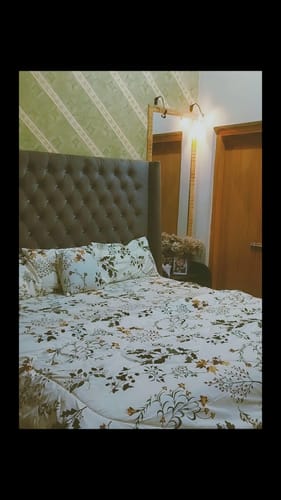 Customer's DEWDROP Comforter Set with a white, green, and brown floral pattern neatly arranged on a bed.
