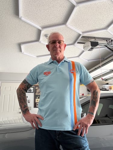 Customer showing the fit of the Gulf Roadmaster Polo in Gulf Blue with its distinctive racing stripes.