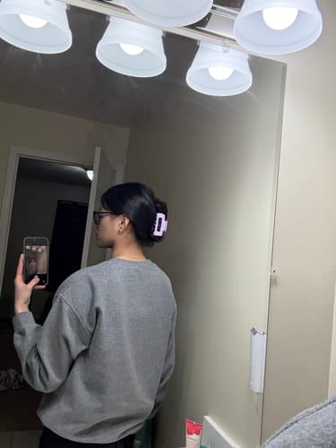 Reviewer with dark hair pulled back, secured neatly with a light purple cloud clip.