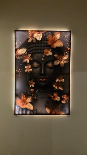Customer's backlit Radiant Floral Buddha Tranquility canvas print hanging on a wall, showing the serene face and gold flowers.