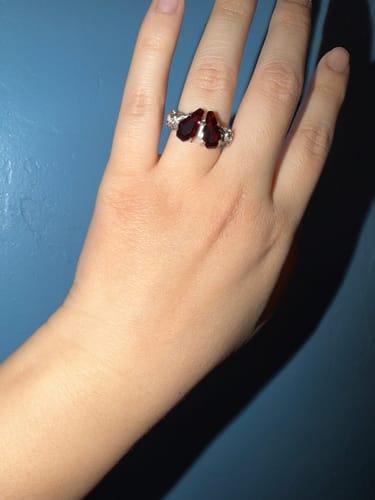 Customer wearing the Promise Ring with two coffin-shaped red stones on their finger.