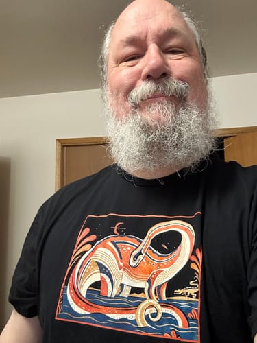 Customer wearing the black Diplodocus Dream T-Shirt, showing the artistic dinosaur graphic.
