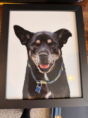 Customer's finished Framed Pet Portrait of a smiling black and tan dog inside a black frame.