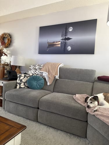 Customer's large Night Lake Wall Art hung above a gray couch in their living room.