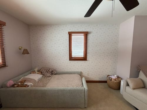 Customer's bedroom with the Wynne Wallpaper applied as a subtle accent wall behind a daybed.