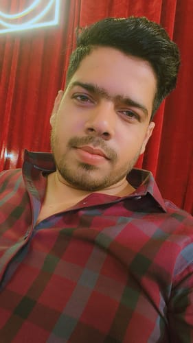 A reviewer takes a close-up selfie wearing the Burgundy Red Checks shirt.