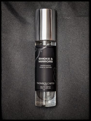 Customer's 10ml travel-size bottle of Smoke & Mirrors Eau de Parfum shown against a dark background.