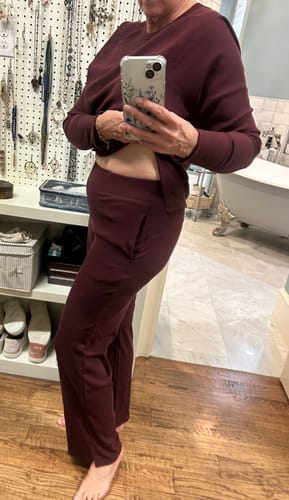 Reviewer showing the fit of the wide-leg Luca Ribbed Pants in Toasted Garnet, highlighting the waistband.