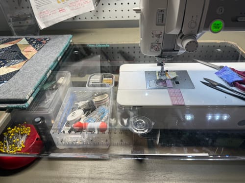Customer's clear Sew Steady extension table fitted snugly around a sewing machine, with notions visible underneath.