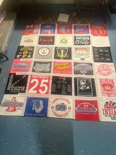 Reviewer's in-progress t-shirt quilt using the Patriotic Love Fabric for the sashing between colorful shirt squares.