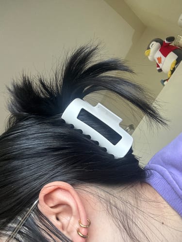 Customer showing the white cloud clip holding up their dark hair.