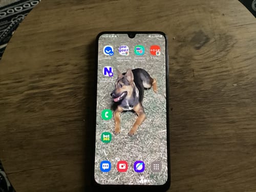 Customer's refurbished Samsung Galaxy A50 turned on, showing the home screen with a custom wallpaper and apps.