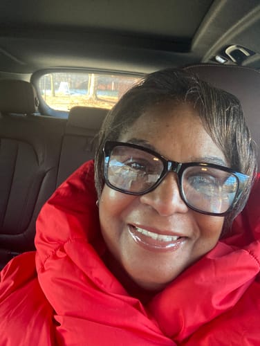 Reviewer smiling, showing her healthy hair after using the BALM Stimulating Scalp and Hair Balm.