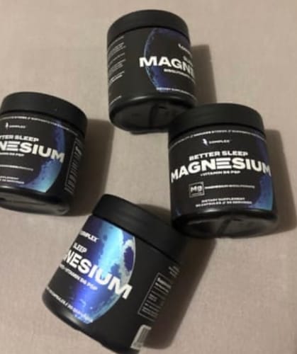 Customer's four black jars of Better Sleep Magnesium supplement arranged on a flat surface.