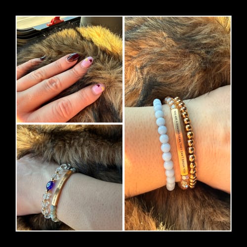 Customer's wrist showing a gold bar bracelet with 'YOU ARE A DIAMOND' text, stacked with other beaded bracelets.