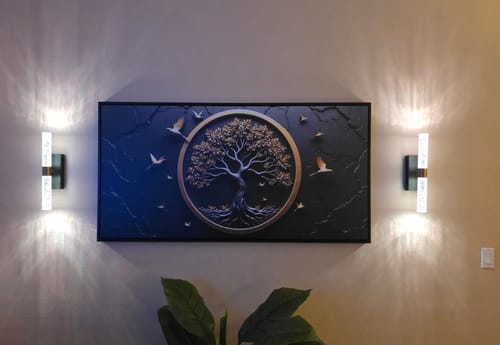 Customer's 3D Celtic Tree of Life Wall Art displayed as a focal piece on a wall between two lit sconces.