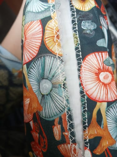 Customer's photo of a clean, finished edge on mushroom-print fabric, created using the Overcasting Foot.