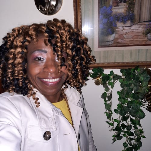 A smiling reviewer in a photo submitted with their review of Keto Activate.