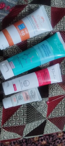Customer's All Glow Pigmentation Bundle, showing all four product tubes arranged on a patterned surface.