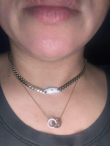 Close-up of a reviewer wearing the shiny Hollow Cuban MONACI Choker on their neck.