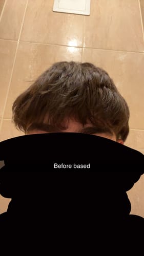 Close-up of a reviewer's hair before styling, appearing flat with minimal texture.