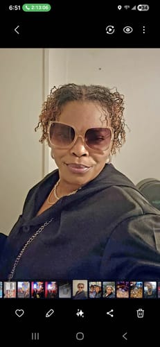 Reviewer showing her defined, curly hair after using the Hydrating Hair Mist.