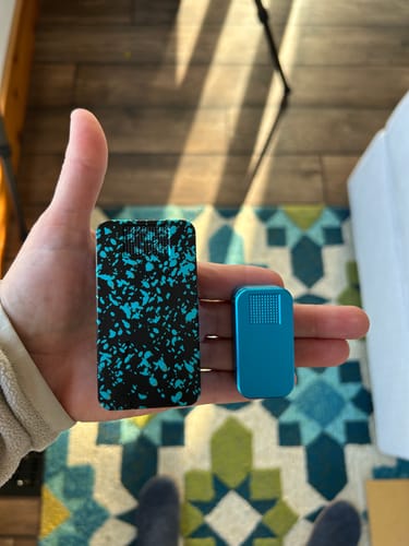 Customer holding two different pill cases in their hand to show a size comparison.