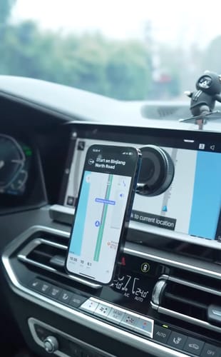 Customer's MagPro Magnetic Phone Holder securely holding a smartphone in portrait mode for navigation in a car.